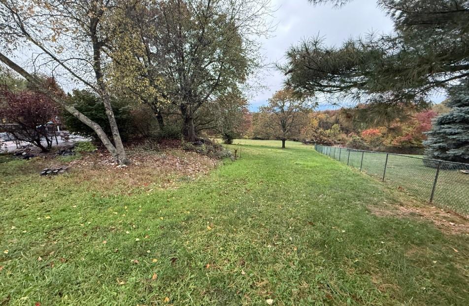 133 Cemetery Road Vanderbilt, PA 15486 - Photo 25 of 29 a backyard of a house with table and chairs
