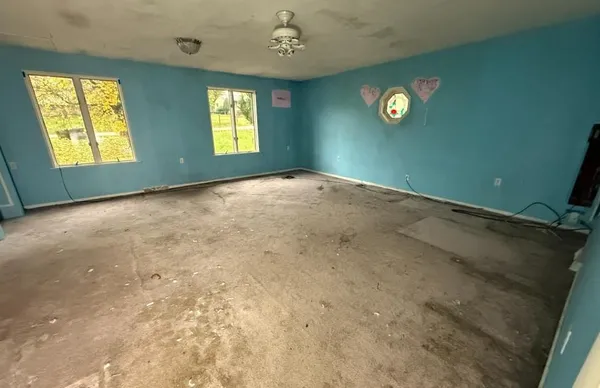 an empty room with windows and closet