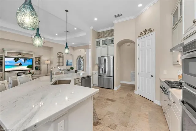 a kitchen with stainless steel appliances granite countertop a refrigerator and a sink