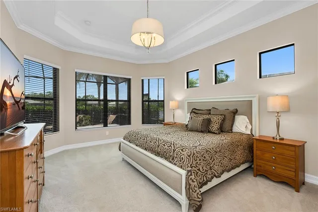 a bedroom with a large bed and a flat tv screen