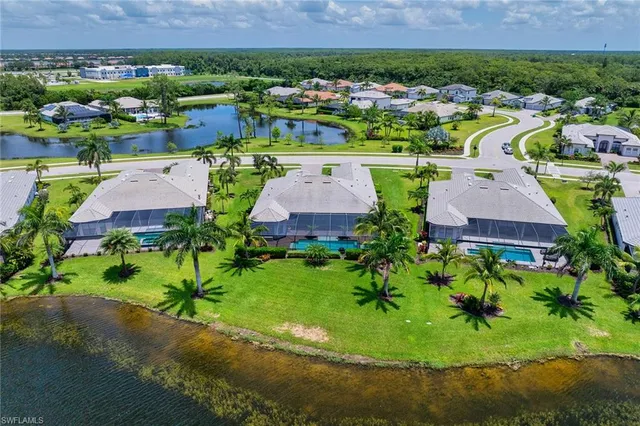 an aerial view of a house with a garden and lake view