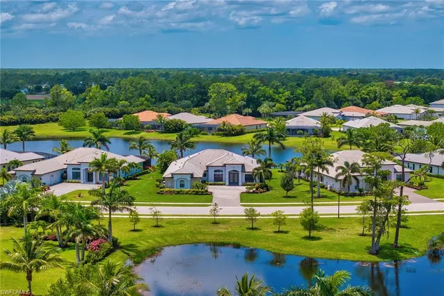 an aerial view of residential houses with outdoor space and swimming pool