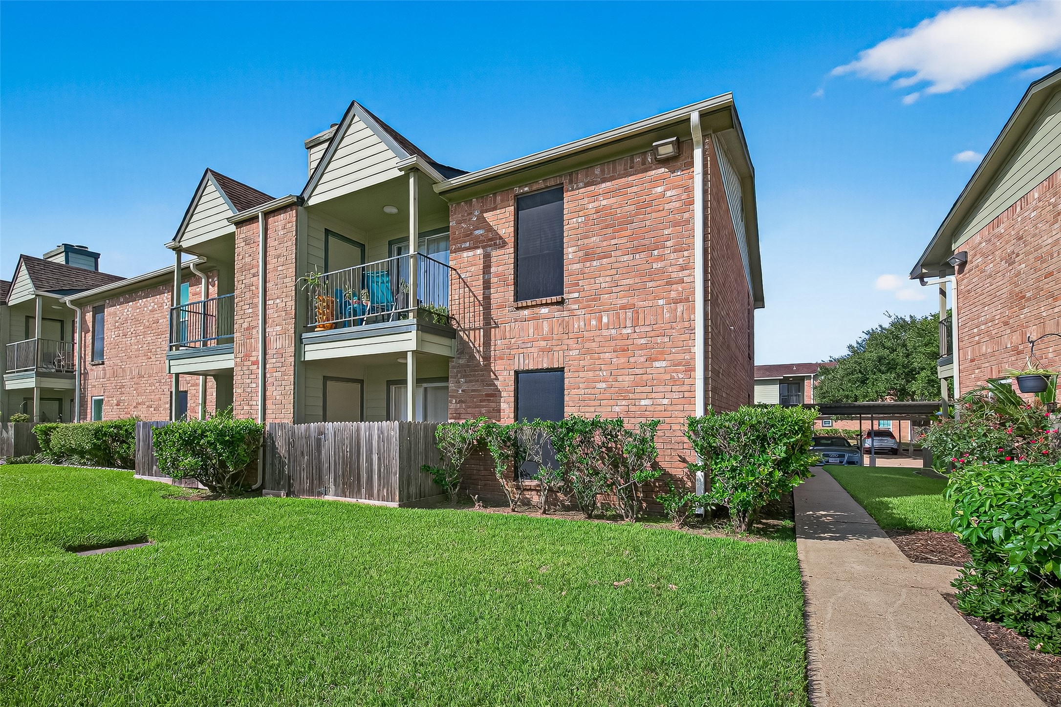 18800 Egret Bay Boulevard, Unit 1207 Webster, TX 77058 - Photo 29 of 30 a view of a house with brick walls and a yard with plants