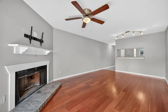 wooden floor in an empty room with a fireplace