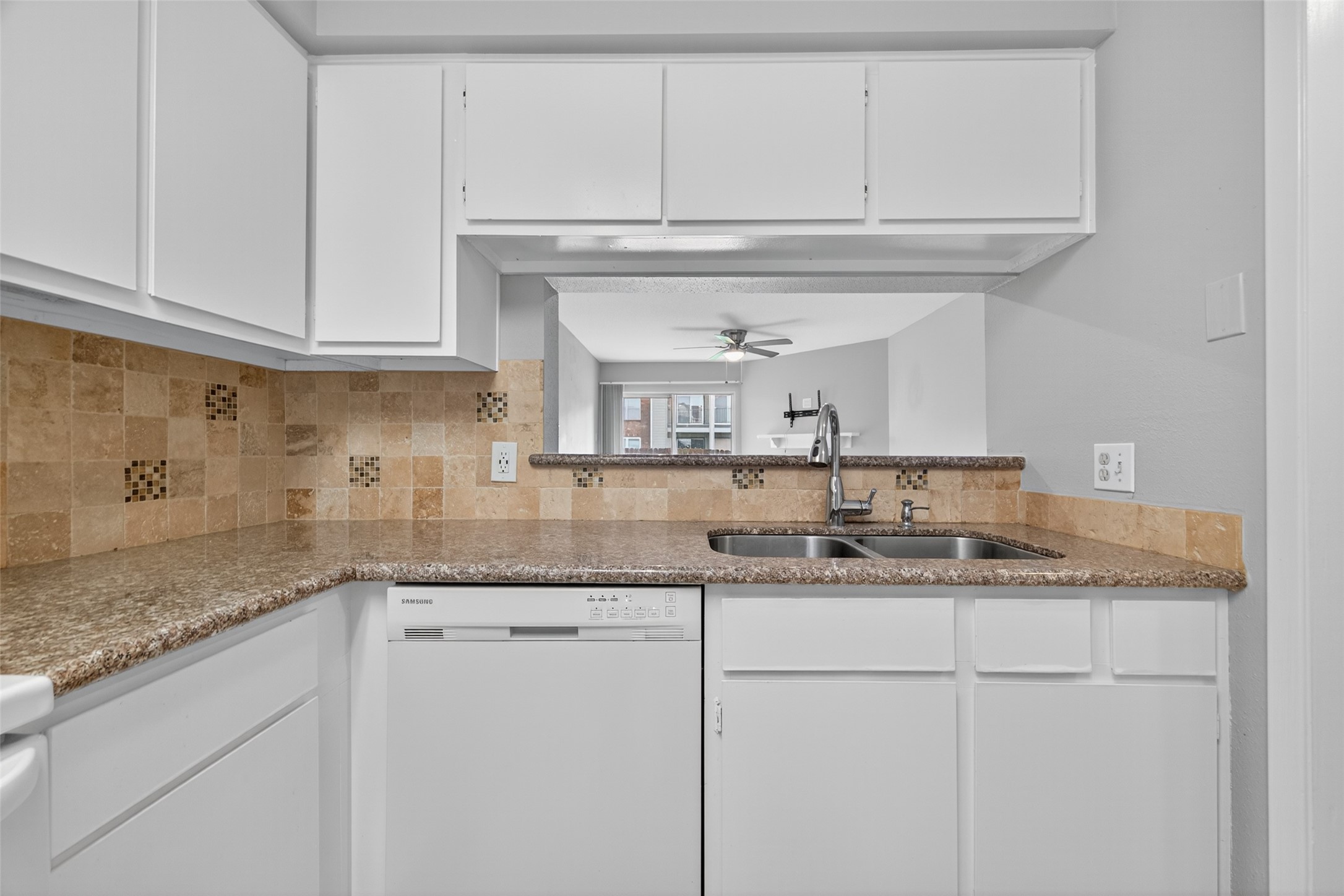 18800 Egret Bay Boulevard, Unit 1207 Webster, TX 77058 - Photo 9 of 30 a kitchen with granite countertop a sink and cabinets