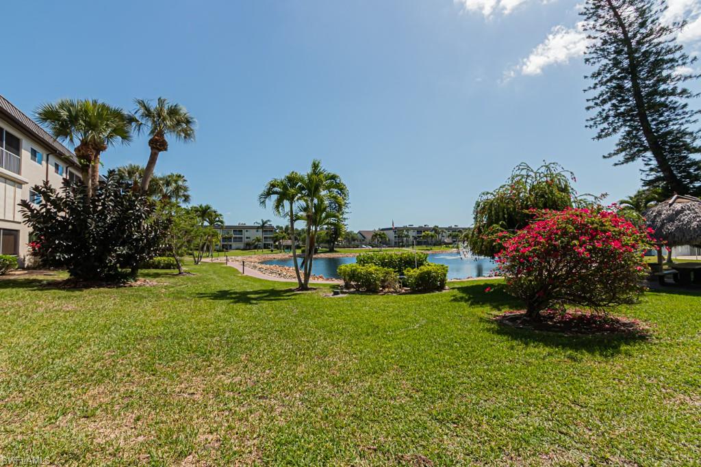 1022 Manatee Road, Unit D107 Naples, FL 34114 - Photo 11 of 43 a view of a garden with a building in the background