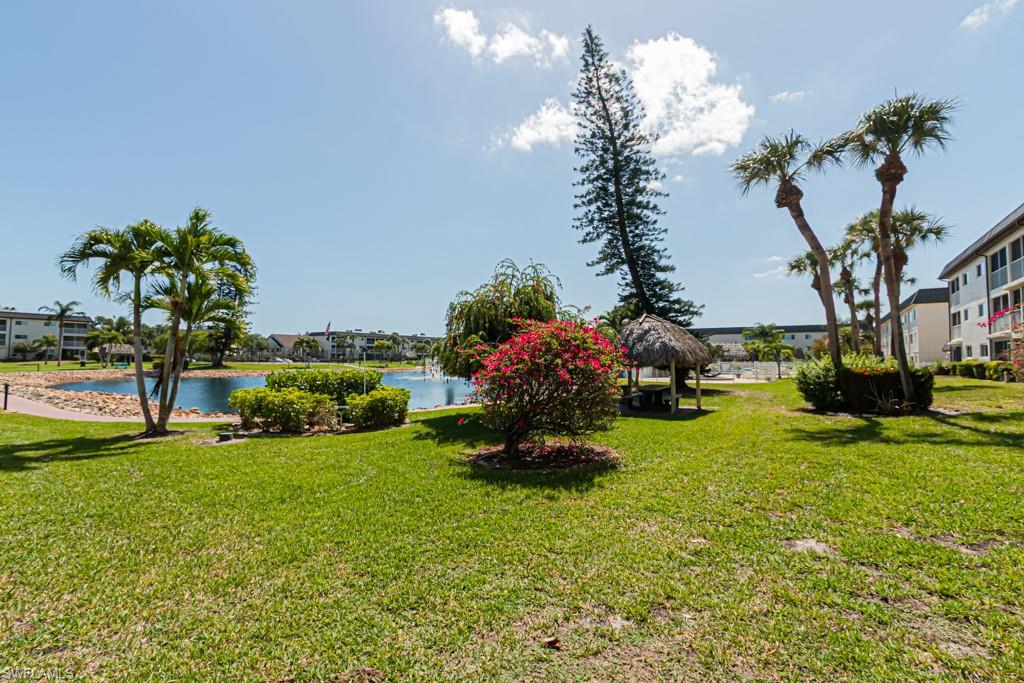 1022 Manatee Road, Unit D107 Naples, FL 34114 - Photo 12 of 43 a view of a garden with plants and large trees