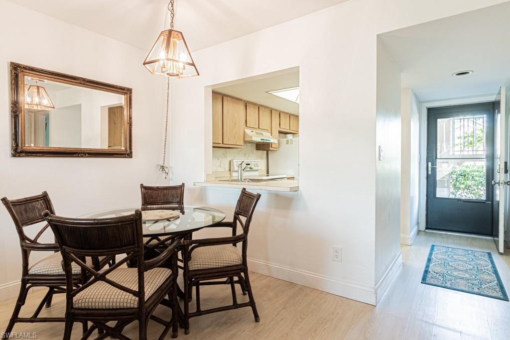 1022 Manatee Road, Unit D107 Naples, FL 34114 - Photo 15 of 43 a view of a dining room with furniture and window