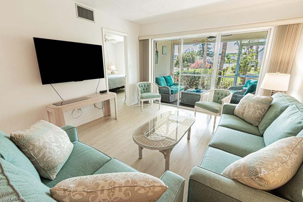 1022 Manatee Road, Unit D107 Naples, FL 34114 - Photo 28 of 43 a living room with furniture and a flat screen tv