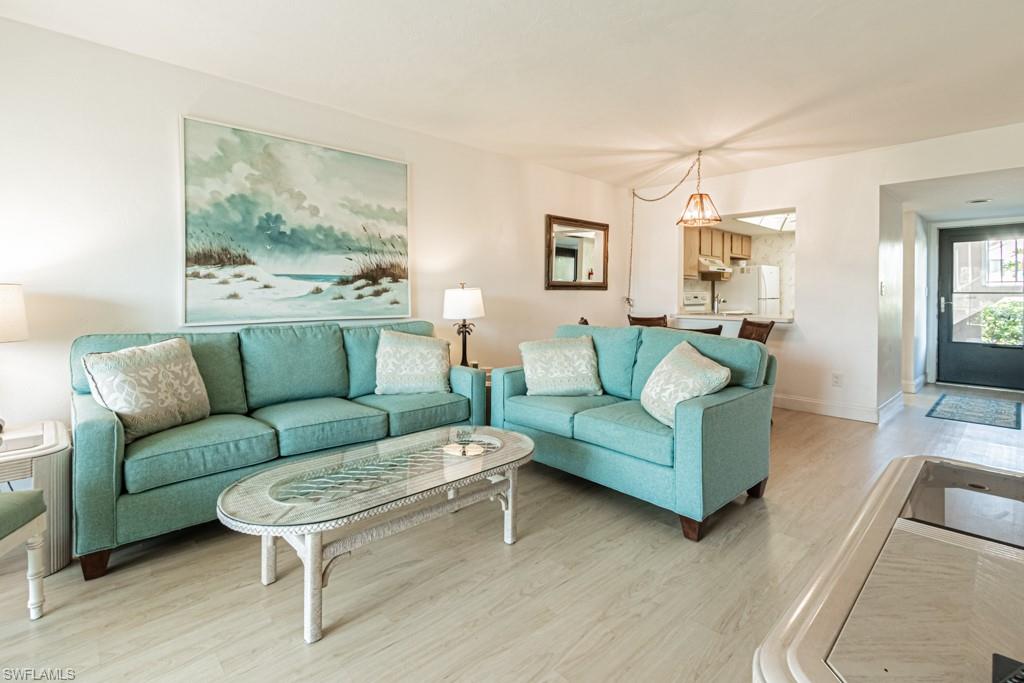 1022 Manatee Road, Unit D107 Naples, FL 34114 - Photo 29 of 43 a living room with furniture and a large window