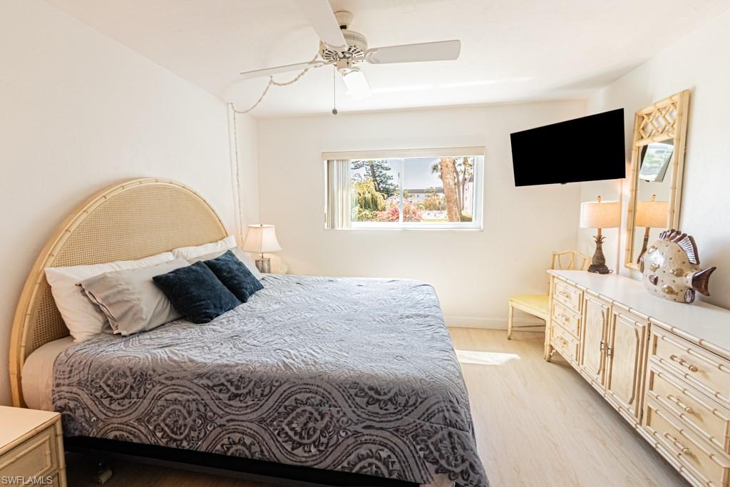 1022 Manatee Road, Unit D107 Naples, FL 34114 - Photo 30 of 43 a bedroom with a large bed and a flat screen tv
