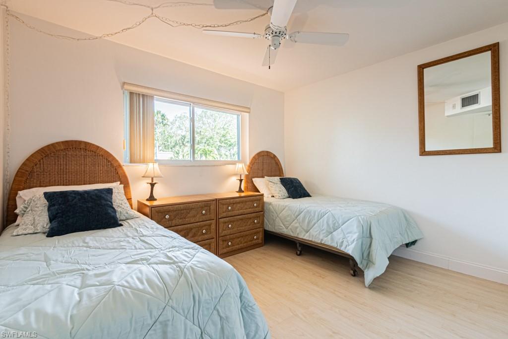 1022 Manatee Road, Unit D107 Naples, FL 34114 - Photo 35 of 43 a bedroom with a bed and a large window