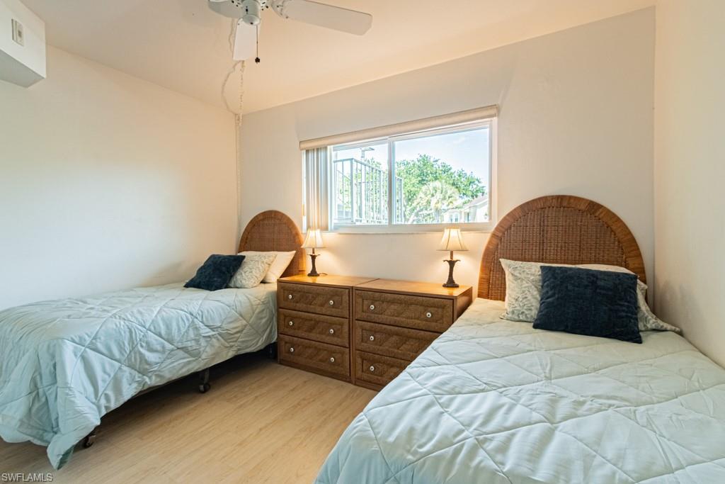 1022 Manatee Road, Unit D107 Naples, FL 34114 - Photo 36 of 43 a bedroom with a bed and a large window