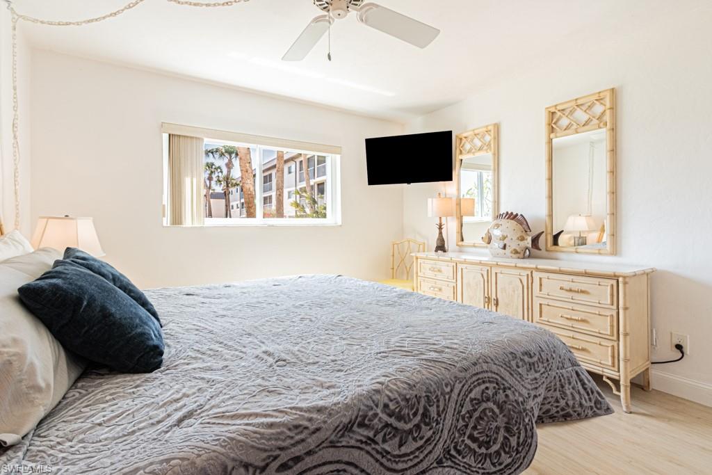 1022 Manatee Road, Unit D107 Naples, FL 34114 - Photo 38 of 43 a bedroom with a bed and a flat tv screen