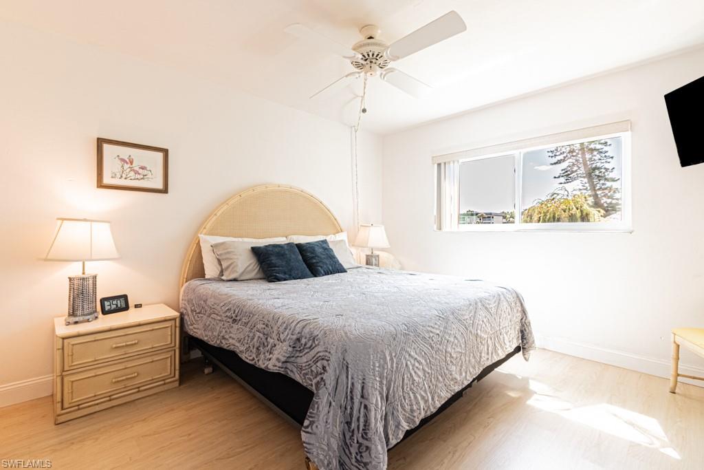 1022 Manatee Road, Unit D107 Naples, FL 34114 - Photo 42 of 43 a bedroom with bed and a night stand