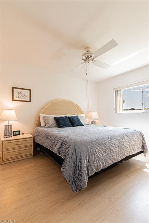 1022 Manatee Road, Unit D107 Naples, FL 34114 - Photo 43 of 43 a bedroom with a large bed and ceiling fan