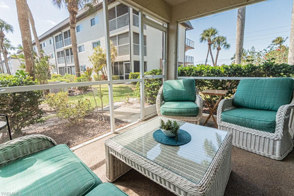 1022 Manatee Road, Unit D107 Naples, FL 34114 - Photo 5 of 43 a view of a patio with couches chairs and a potted plant