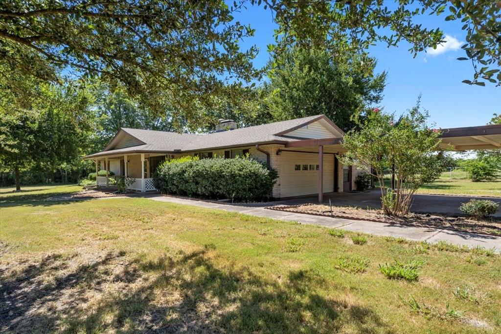 705 West Saunders Street Trenton, TX 75490 - Photo 13 of 37 a house with swimming pool in front