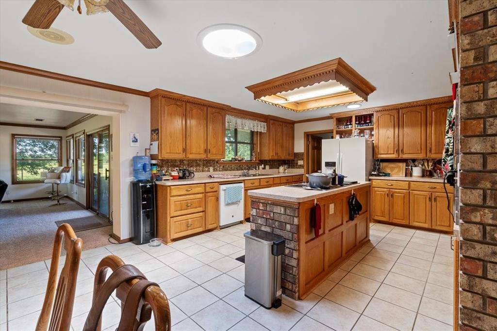 705 West Saunders Street Trenton, TX 75490 - Photo 17 of 37 a kitchen with stainless steel appliances granite countertop a stove oven and a refrigerator