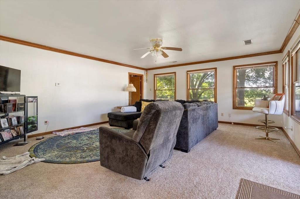 705 West Saunders Street Trenton, TX 75490 - Photo 18 of 37 a living room with furniture and a flat screen tv