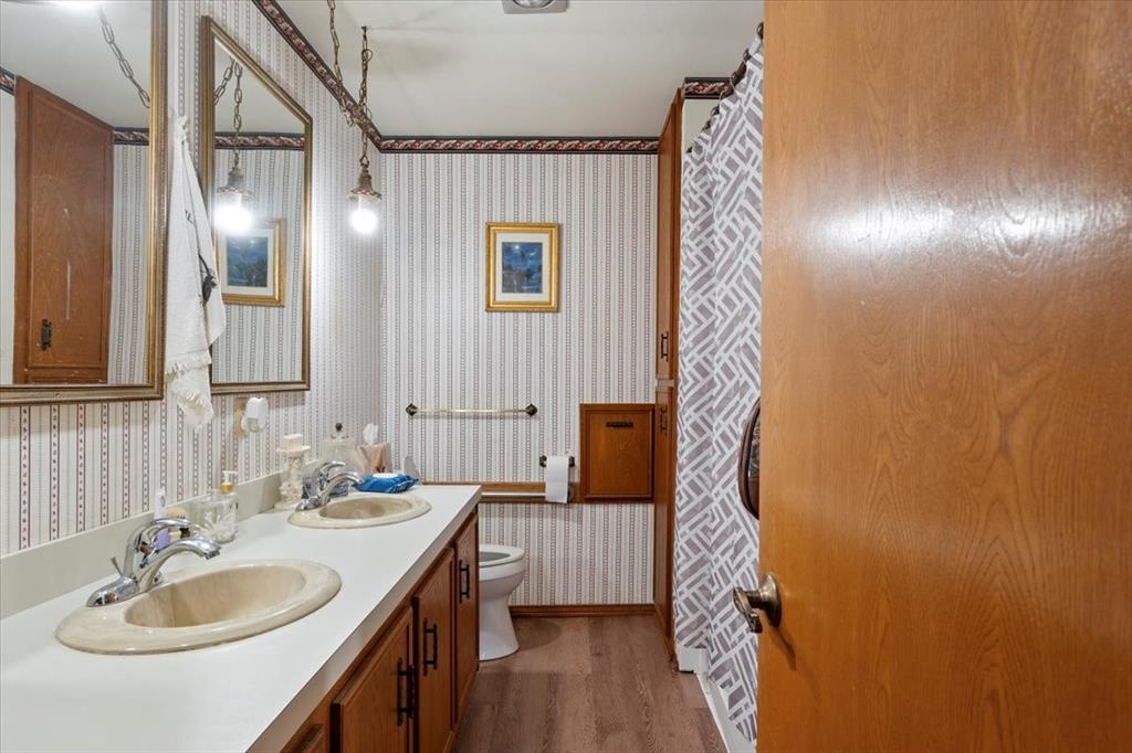 705 West Saunders Street Trenton, TX 75490 - Photo 20 of 37 a bathroom with a sink and a mirror