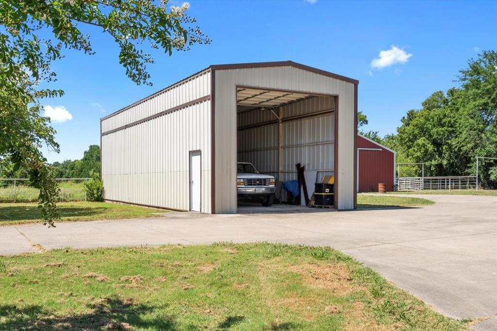 705 West Saunders Street Trenton, TX 75490 - Photo 26 of 37 a view of a house with a yard and garage