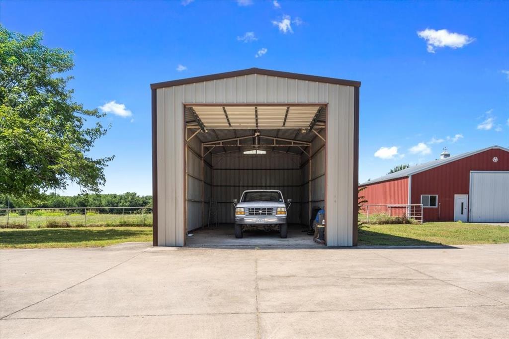 705 West Saunders Street Trenton, TX 75490 - Photo 27 of 37 a car parked in front of a building with a yard