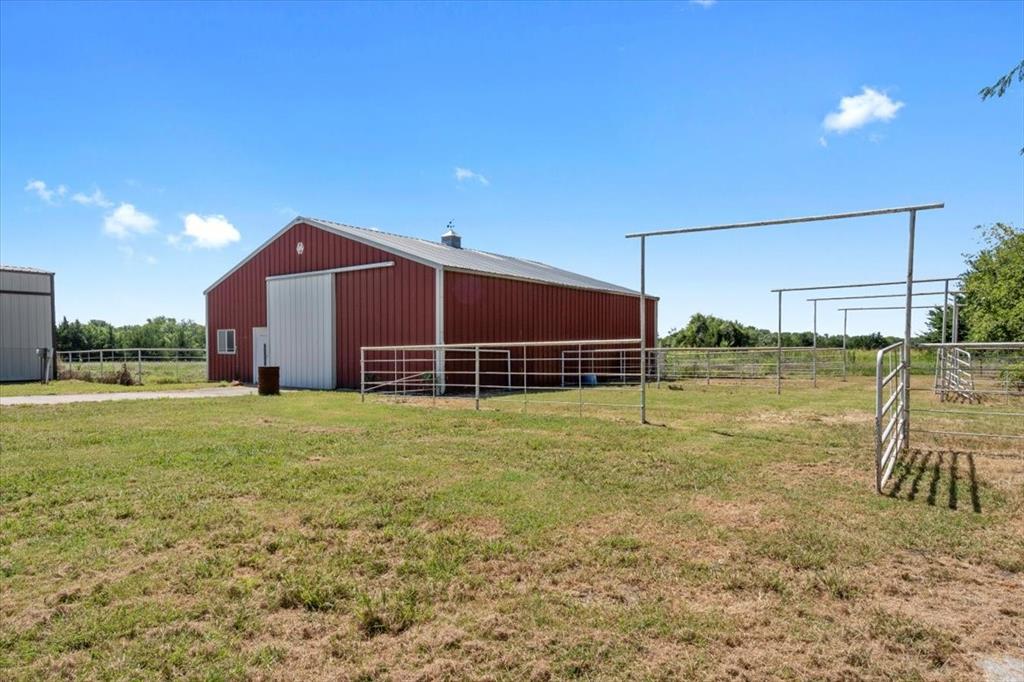 705 West Saunders Street Trenton, TX 75490 - Photo 28 of 37 a view of a backyard with a garden and deck
