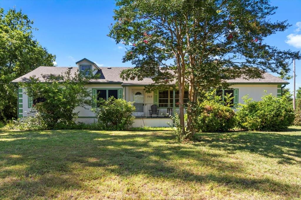 705 West Saunders Street Trenton, TX 75490 - Photo 5 of 37 a view of a house with a yard