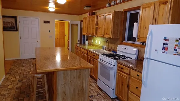 a view of a hallway with furniture and wooden floor