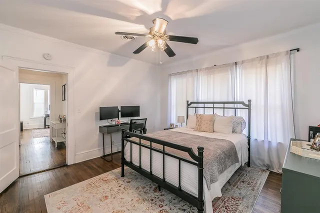 a bedroom with a bed and a desk