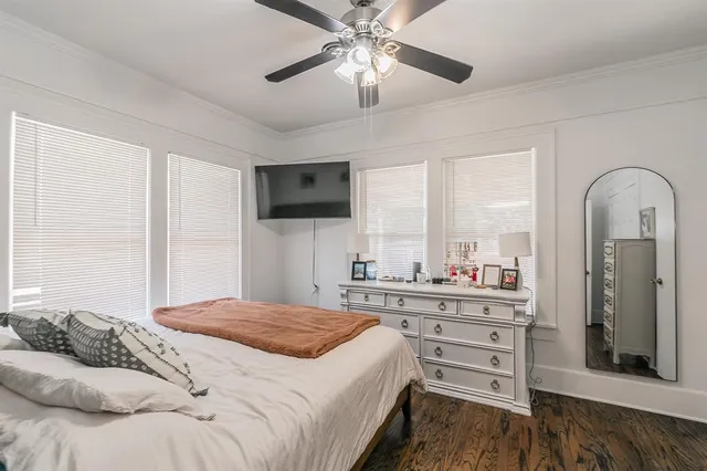 a bedroom with a large bed and a chandelier