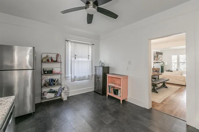 a kitchen with granite countertop a sink cabinets stainless steel appliances and a window