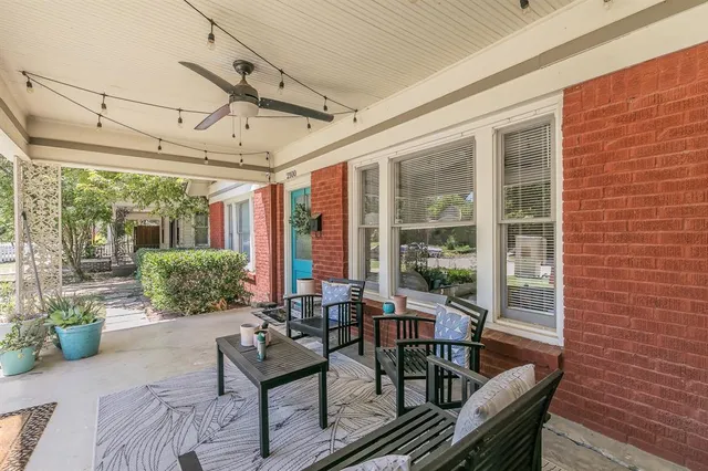 a view of a patio with couches table and chairs and potted plants