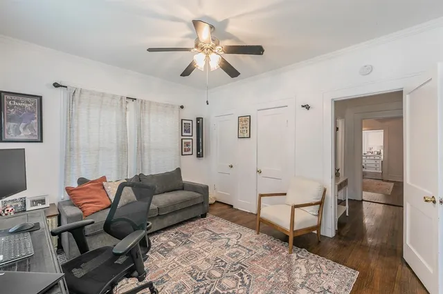 a living room with furniture and a dining table