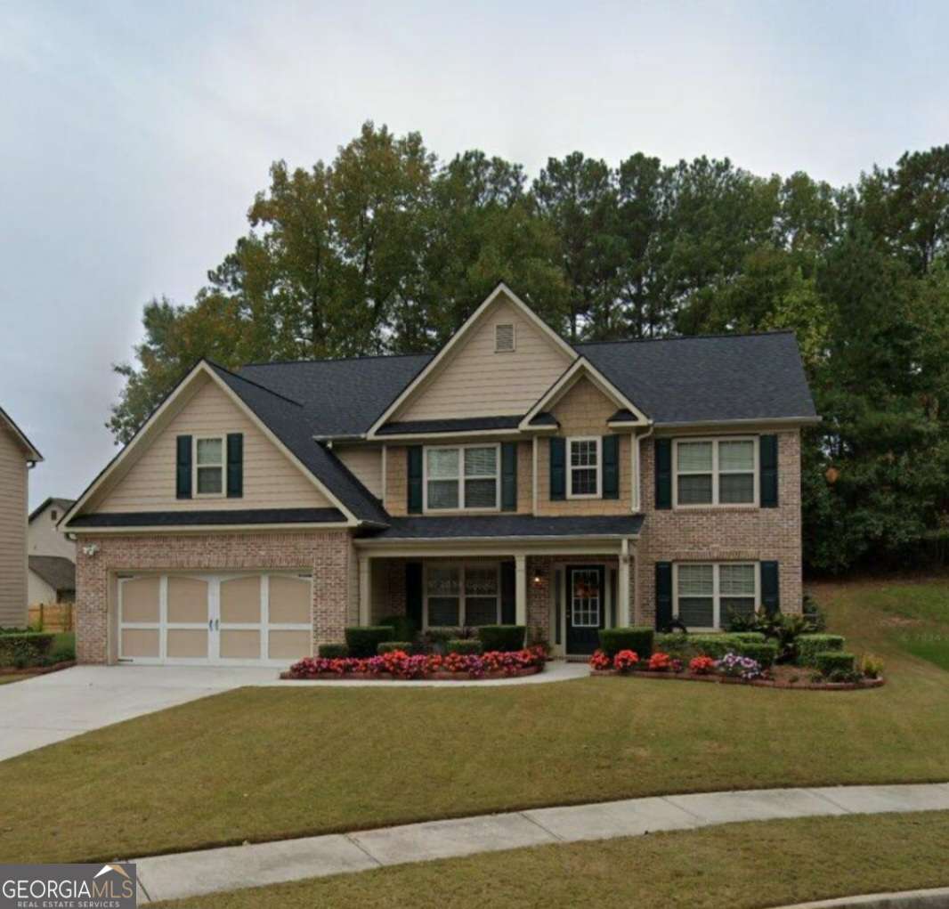 3181 Arbor Oaks Way Southwest Snellville, GA 30039 - Photo 1 of 12 a front view of a house with a garden
