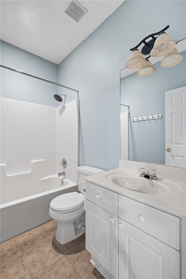 1213 North Dean Road Auburn, AL 36830 - Photo 15 of 18 This bright bathroom features a spacious tub and a practical vanity.