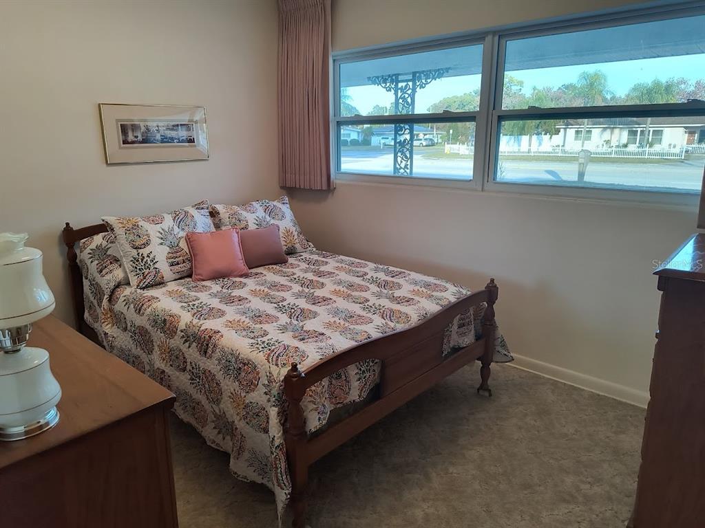 732 Keene Road Largo, FL 33771 - Photo 13 of 38 a bed sitting in a bedroom next to a window