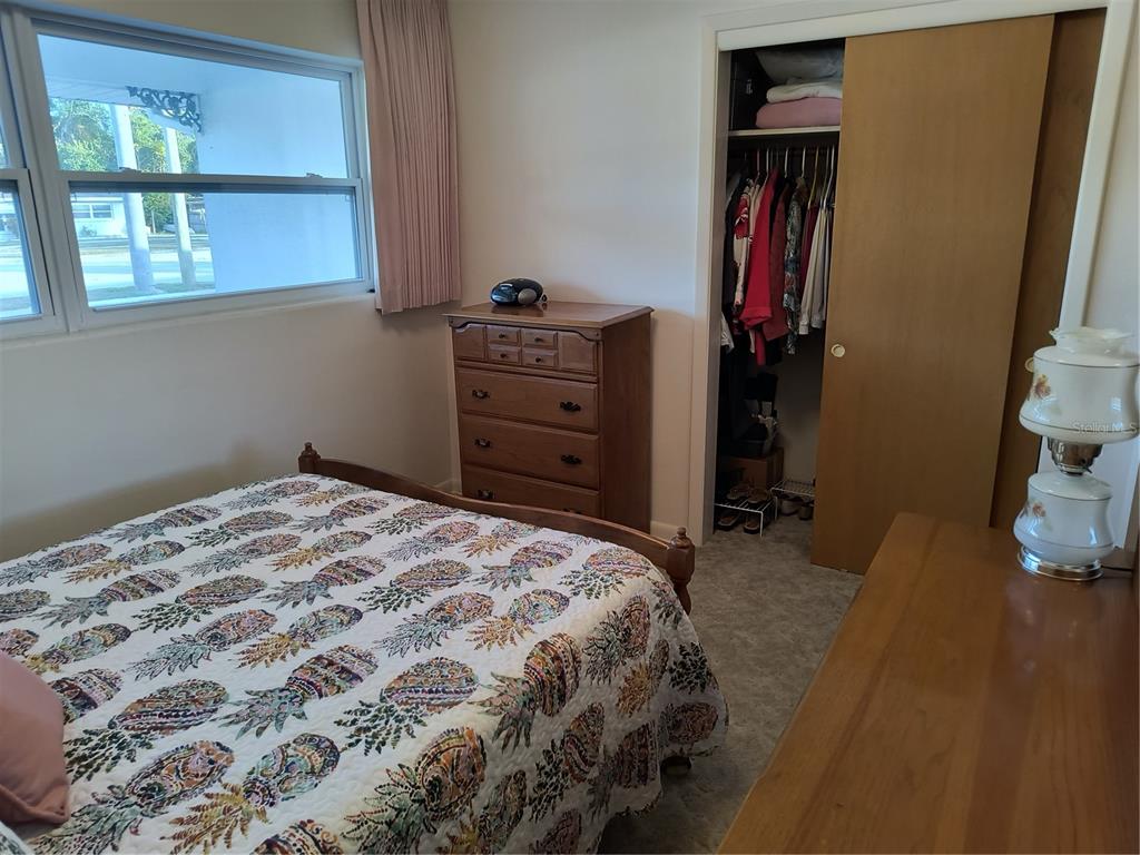 732 Keene Road Largo, FL 33771 - Photo 14 of 38 a bedroom with a bed and a window