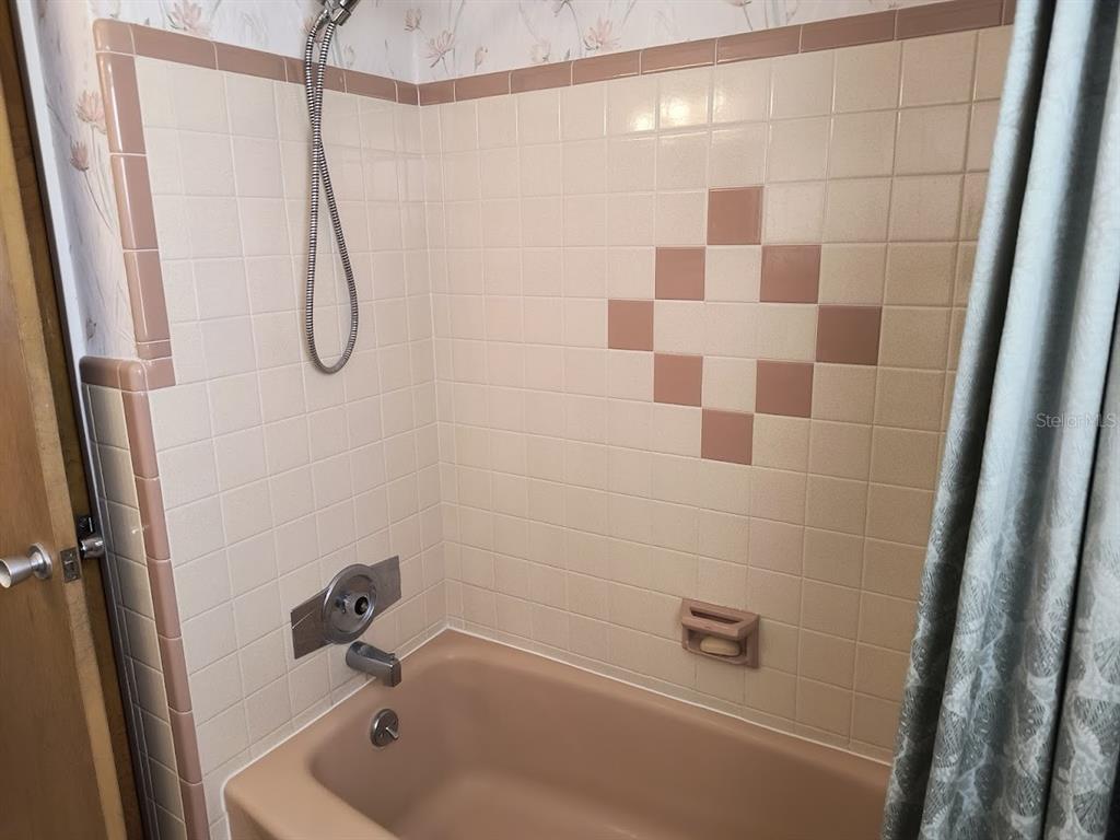 732 Keene Road Largo, FL 33771 - Photo 17 of 38 a bathroom with a shower and a bathtub