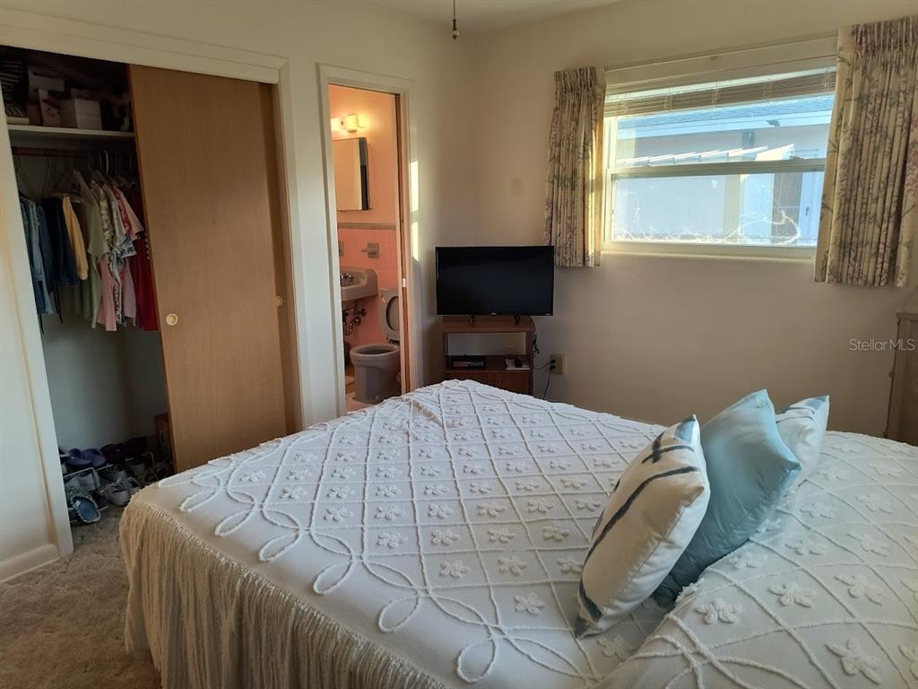 732 Keene Road Largo, FL 33771 - Photo 25 of 38 a bed sitting in a bedroom next to a window