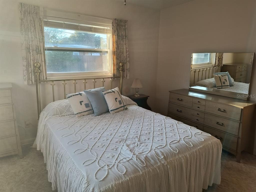 732 Keene Road Largo, FL 33771 - Photo 26 of 38 a bedroom with a bed and a window