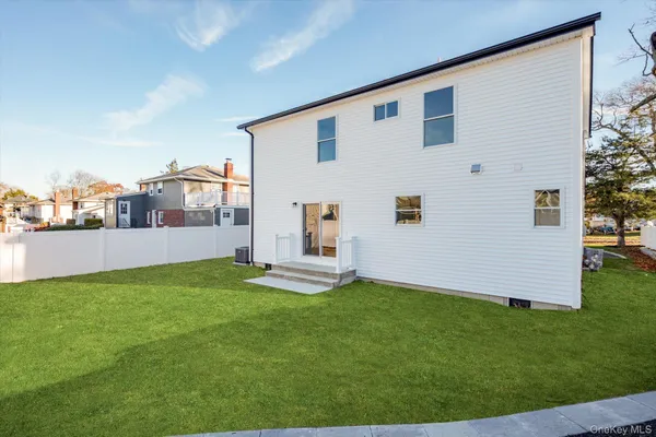 a backyard of a house with table and chairs