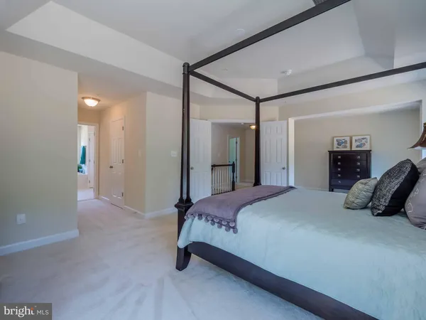 a bedroom with a bed and a mirror