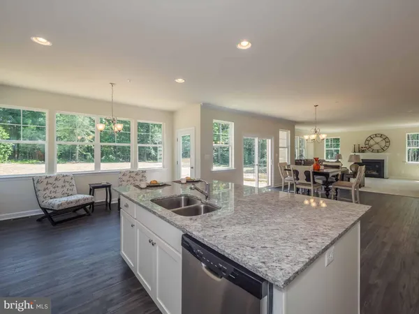 a kitchen with counter top space and wooden floor