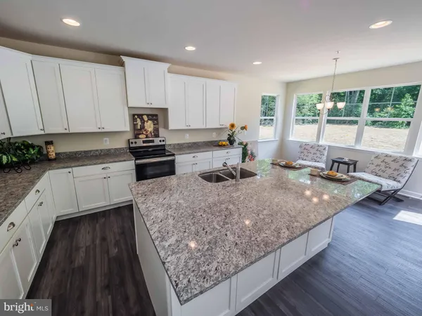 a kitchen with a stove a sink a refrigerator and window