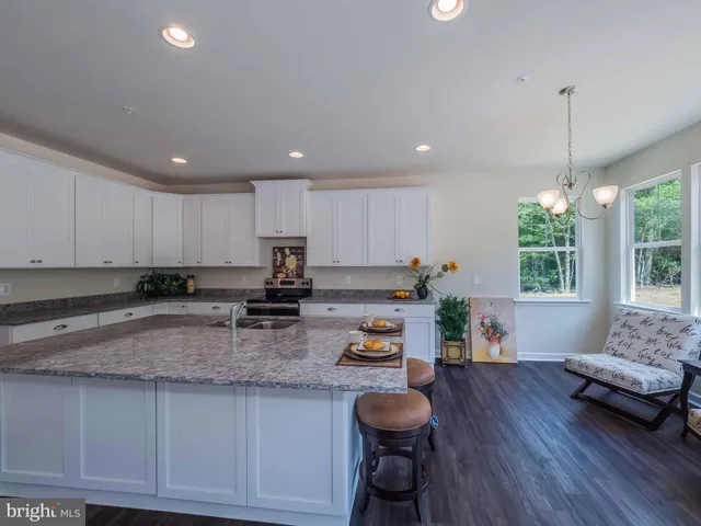 a kitchen with granite countertop lots of counter top space and furniture