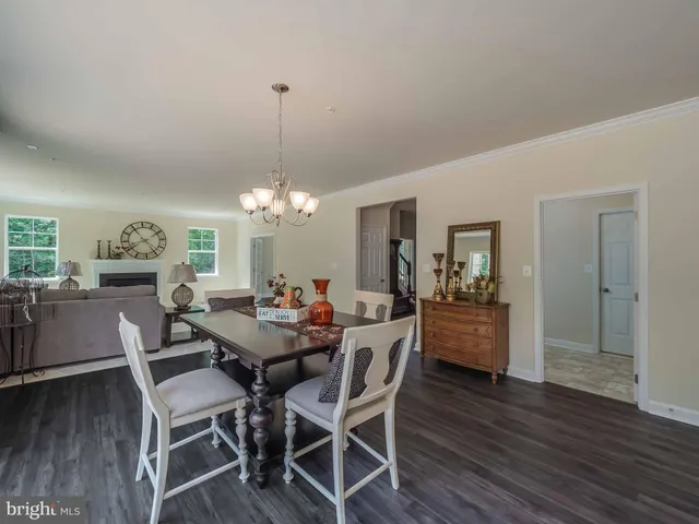 a view of a dining room with furniture wooden floor and chandelier