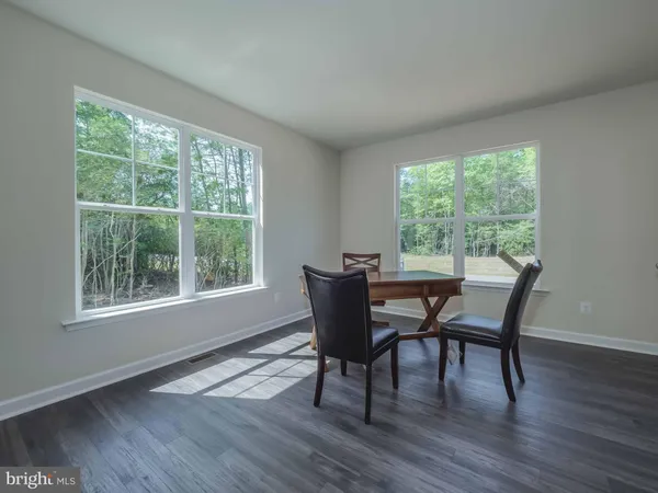 a dining room with furniture window outside view and wooden floor