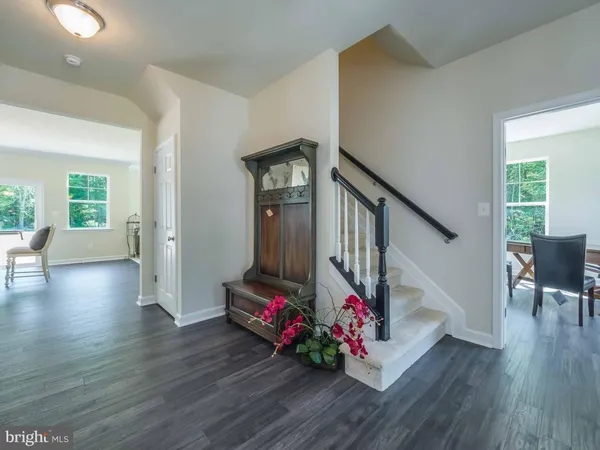 a living room with furniture and stairs